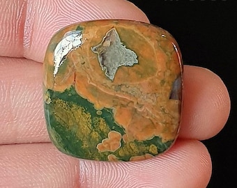 May include: A polished, square-shaped gemstone with a mix of colors. The stone features a base of green and orange hues, with a prominent gray star-shaped inclusion. The text "M-5589" is visible in the upper right corner.