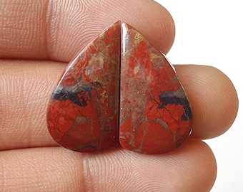 May include: Two red, brown, and black heart-shaped cabochons with a marbled pattern. The cabochons are approximately 1 inch in length.