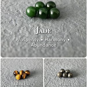 May include: The image showcases three sets of gemstones: jade, tiger eye, and pyrite. The jade stones are a deep green, the tiger eye stones are brown with golden streaks, and the pyrite stones are metallic gray. Text labels identify each stone and associated qualities.