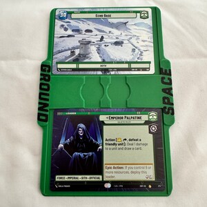 May include: A green card game with two cards showing. The top card is a base card called "Echo Base" with a picture of a snowy landscape and a building. The bottom card is a leader card called "Emperor Palpatine" with a picture of the character in a black robe and a throne. The card text reads "Action [,, defeat a friendly unit]: Deal 1 damage to a unit and draw a card. Epic Action: If you control 8 or more resources, deploy this leader."
