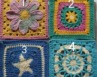 May include: Four crocheted squares with different designs. The first square is yellow with a pink flower in the center. The second square is green with a yellow flower in the center. The third square is blue with a white star in the center. The fourth square is turquoise with a white circle in the center.