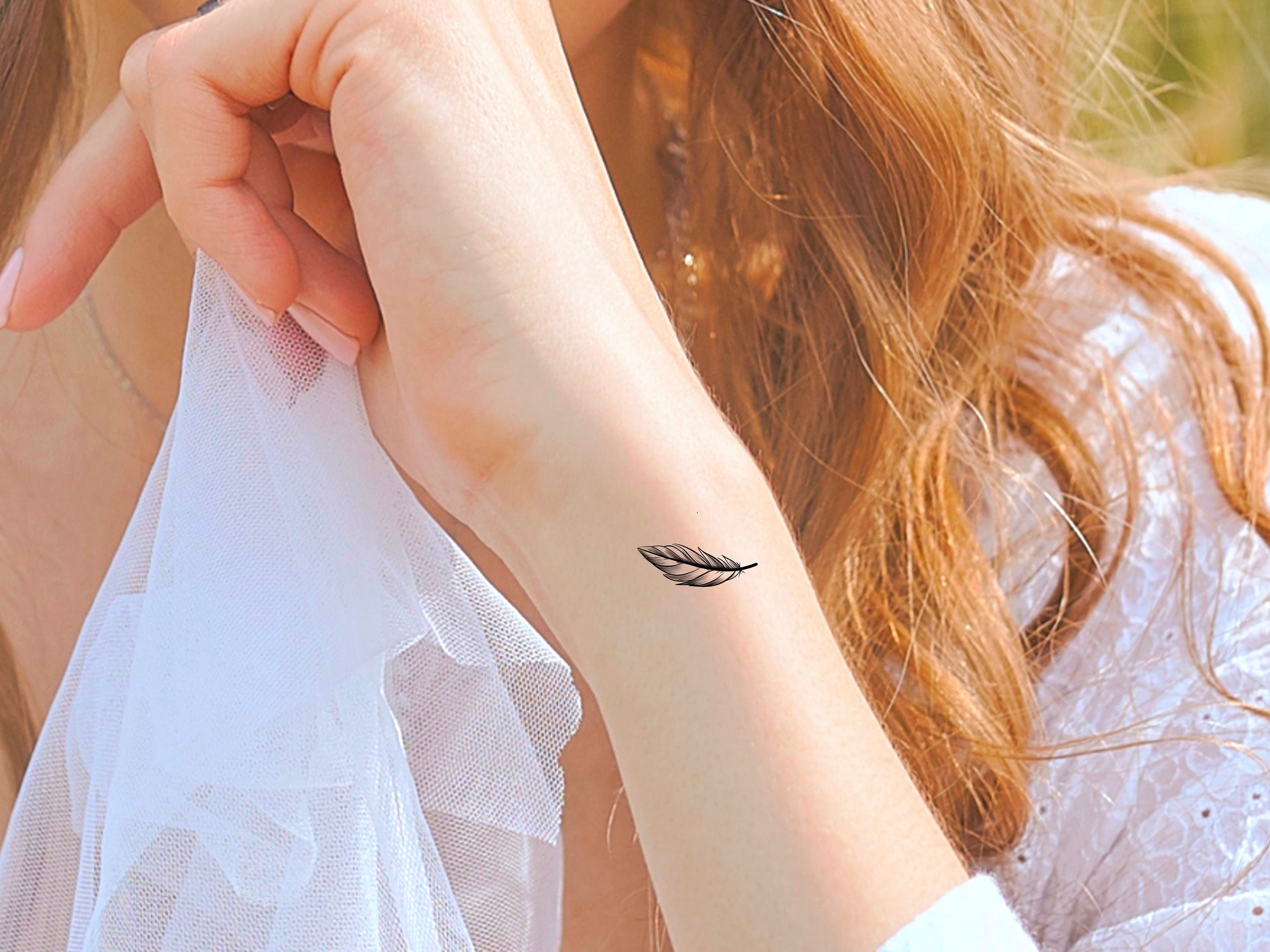 3. Small Feather Tattoos for Ladies - wide 8
