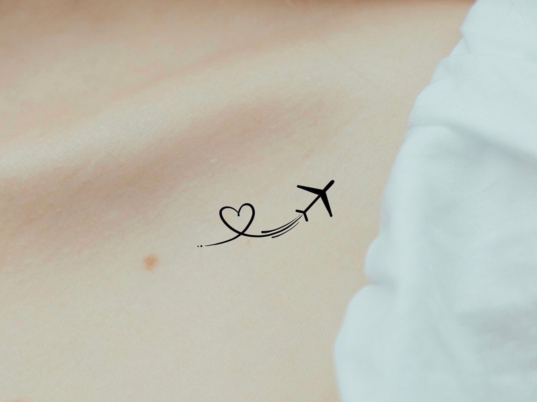 Just inked. Small, elegant... airplane tattoo