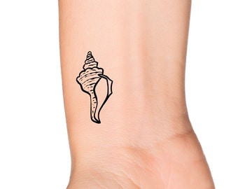 May include: A black and white line drawing of a seashell on a person's wrist.