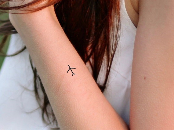 Airplane heartbeat temporary tattoo located on the