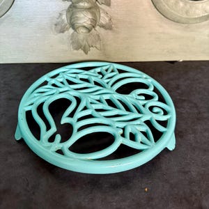 Antique French enameled cast iron trivet, shabby chic style.