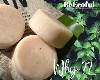 May include: Close-up of several round, light-colored soap bars. The bars are arranged on a neutral linen surface, with a background of green leaves. The text "BeEcofull" and "Why ??" are visible.