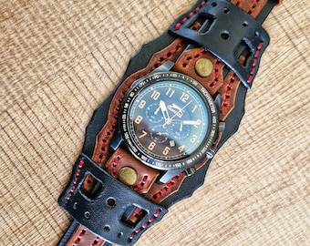 May include: A black and brown leather watch band with a chronograph watch face. The watch face has a black background with white numbers and hands. The watch band has a red stitching detail.