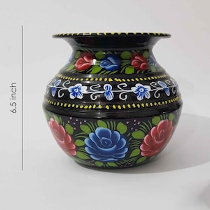 May include: A black metal vase with hand-painted floral designs in shades of red, blue, and green. The vase is 6.5 inches tall.