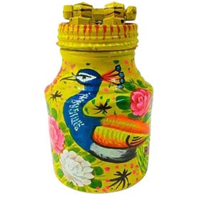 May include: A yellow painted jar with a peacock design and floral accents. The jar has a wooden lid with a decorative design.