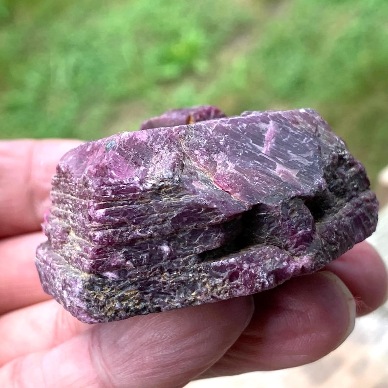 Side profile raw ruby crystal, burgundy, striated sides and rough texture, large ruby mineral specimen.