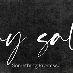 May include: A rectangular black sign with the words "stay salty" in white cursive script. Below the phrase, the text "Something Promised" is written in a smaller, sans-serif font. The sign has a distressed, textured appearance.