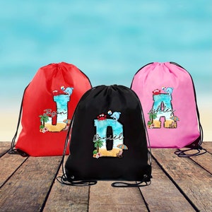 May include: Three drawstring bags in red, black, and pink, each featuring a large letter printed with a beach scene, a dolphin, a crab, and a beach ball. The letters are personalized with the names Jason, Daniel, and Ashley in script font.