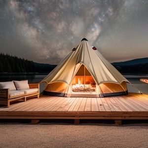 May include: A large beige canvas tent with a wood-burning fireplace inside, set on a wooden platform overlooking a lake. The tent is lit from within, and the night sky is visible above, filled with stars.