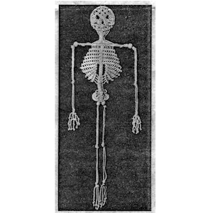 May include: A black and white image of a macrame skeleton. The skeleton is made of a light-colored material, possibly rope or yarn, and is displayed against a dark background. The macrame skeleton is a unique decorative item.