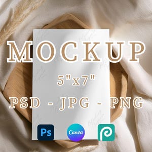 May include: A white 12.7cm x 17.8cm mockup card with the word "MOCKUP" in brown letters. The card is on a wooden tray, with the text "PSD - JPG - PNG" below. Software icons for Photoshop, Canva, and a third app are also visible.