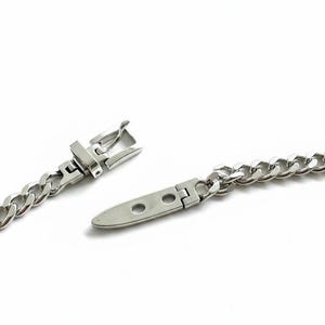Extreme close-up of the open clasp mechanism showing the "S925" hallmark for the 1-micron sterling silver plating quality.
