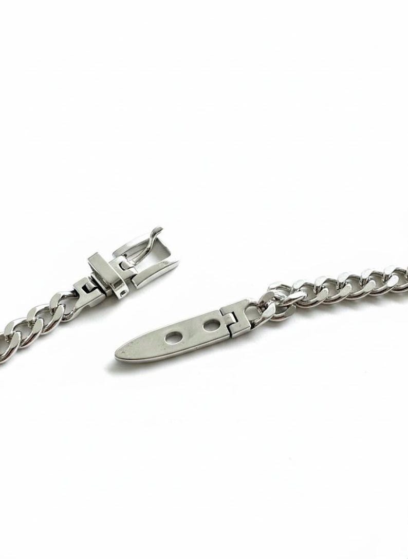 Extreme close-up of the open clasp mechanism showing the "S925" hallmark for the 1-micron sterling silver plating quality.