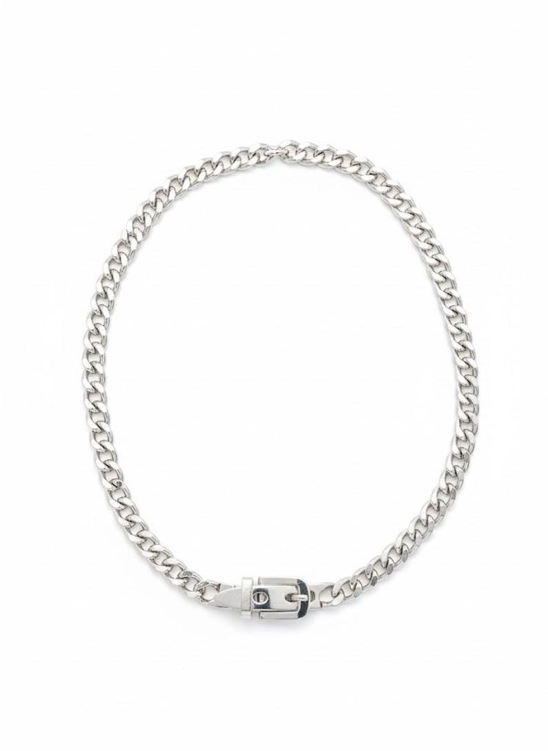 Professional product photography of the silver buckle choker in a perfect circle on a clean white background.