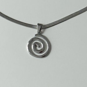 A clear, professional product shot of the stainless steel snake chain and hypnotic swirl pendant, emphasizing its tarnish-proof and waterproof properties.