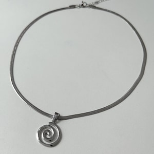 The entire spiral necklace laid out in a circle on a white background, clearly showing the lobster claw clasp and 5cm extender.