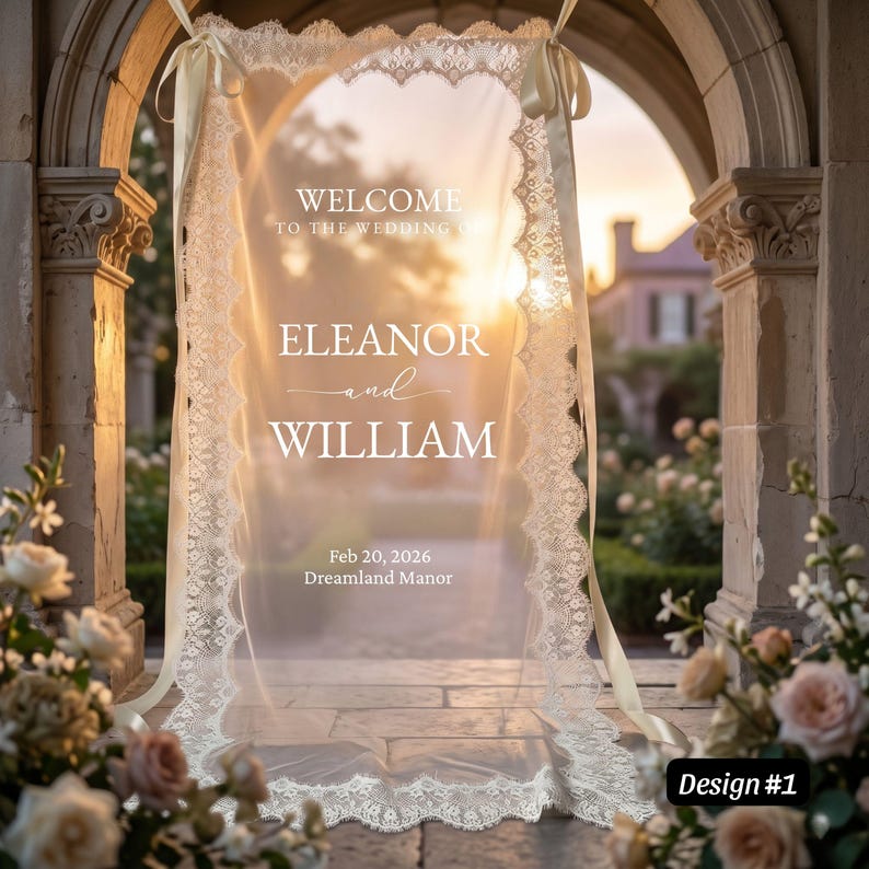May include: A rectangular, translucent wedding welcome sign featuring white text that reads: WELCOME TO THE WEDDING OF ELEANOR and WILLIAM, Feb 20, 2026, Dreamland Manor. The sign is framed by cream-colored lace trim and suspended by matching ribbons.