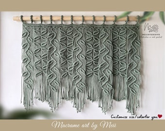 May include: Sage green macrame wall hanging with a geometric pattern. The hanging is attached to a wooden dowel rod. "Customize size/color for you" is written below the hanging.