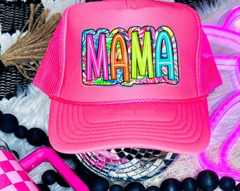 May include: Pink trucker hat with a colorful "MAMA" design. The hat has a mesh back and a black bill. The hat is a DTF transfer.