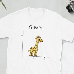 May include: White t-shirt featuring a graphic of a giraffe on a graph with the text "G-RAPH".