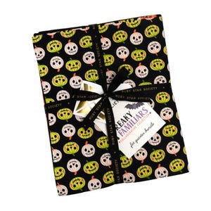May include: A bundle of fabric squares featuring a Halloween pumpkin design in black, white, and yellow. The fabric is tied with a black ribbon with white text. A tag with the words "REAKY FAMILIARS" is attached.