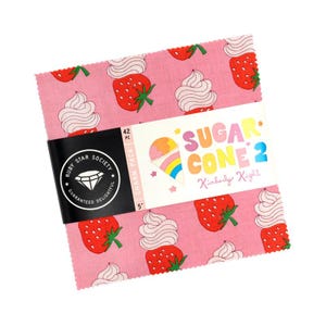 May include: A stack of 5-inch fabric squares with a pink strawberry and whipped cream pattern. The fabric is wrapped with a black band featuring the Ruby Star Society logo and the text "Sugar Cone 2" by Kimberly Kight.
