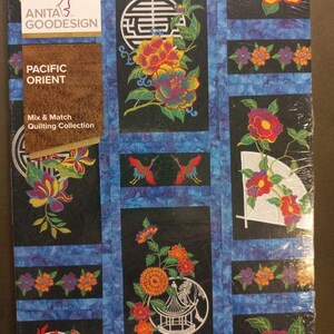 May include: A Pacific Orient Mix & Match quilting collection by Anita Goodesign. The quilt features floral and geometric designs in vibrant colors on a black background, with blue borders. The package is sealed in clear plastic.