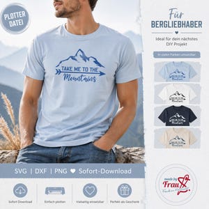 Puede incluir: Camiseta azul claro con el texto "TAKE ME TO THE Mountains" en azul oscuro. El diseño presenta una cordillera. La camiseta la lleva una persona con vaqueros azules.
