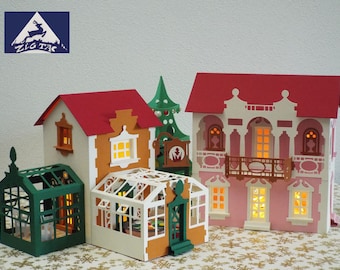 May include: A papercraft model of a Christmas village featuring three buildings, a green greenhouse, and a decorated Christmas tree. The buildings are crafted from paper and have red roofs, white walls, and brown trim. The greenhouse is made of green paper and has a glass roof. The Christmas tree is made of green paper and is adorned with red and gold baubles.