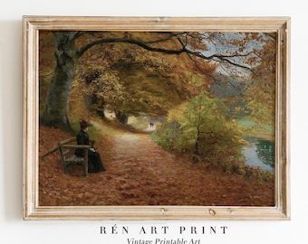 May include: A vintage painting depicting a woman seated on a bench along a forest path. The trees are in autumnal hues, and the path is strewn with fallen leaves. A river can be seen in the background.
