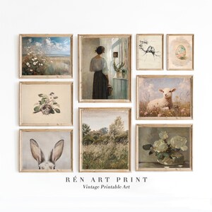 May include: A collection of framed vintage art prints. The prints feature pastoral landscapes, floral arrangements, and animal portraits, including a lamb, a rabbit, and a woman looking out a window. The prints are in wooden frames.