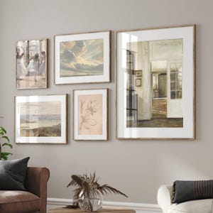 May include: A gallery wall featuring five framed prints. The prints depict a range of subjects, including a landscape, a still life, and a group of dancers. The frames are all wooden and have a light brown finish.