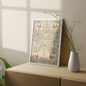 May include: A framed print of a botanical illustration featuring a repeating pattern of stylized flowers and leaves in shades of green, brown, and white.