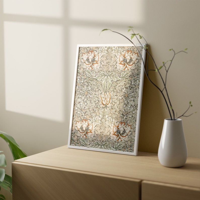 May include: A framed print of a botanical illustration featuring a repeating pattern of stylized flowers and leaves in shades of green, brown, and white.