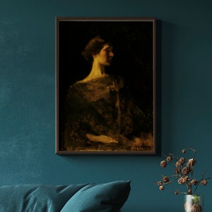 May include: Framed portrait of a woman in profile, rendered in muted tones of gold and black. The artwork, set against a dark background, features a woman with her hair up, wearing a draped garment. The painting is in a dark wooden frame.