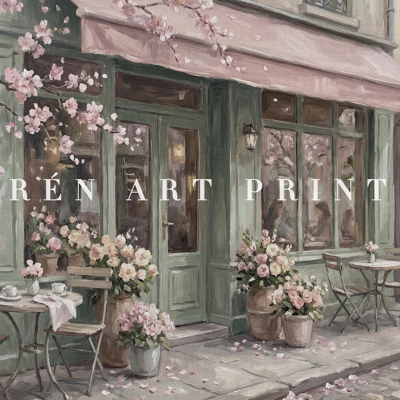 May include: An artistic painting of a cafe exterior with a pink awning and green trim. The storefront features large windows, tables, and chairs. The text "R&Eacute;N ART PRINT" is visible. Potted flowers and cherry blossoms add a touch of color.
