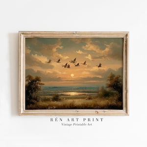 May include: A framed vintage art print depicts a sunset scene with a flock of birds in flight. The artwork features a warm color palette of orange, yellow, and brown, with the text "RÉn Art Print" and "Vintage Printable Art" at the bottom.