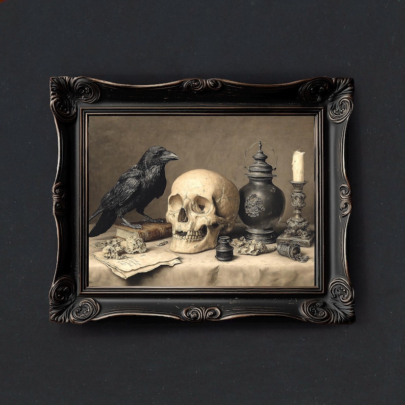 May include: A framed still life painting featuring a black raven, a human skull, a vintage lantern, a candle, and a book. The artwork has a dark, gothic aesthetic, with a black ornate frame and a neutral background.