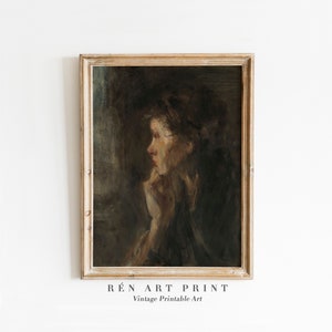 May include: A vintage oil painting in a wooden frame depicts a woman with dark hair, wearing a dark dress, looking to the side. The painting has a muted color palette with browns, blacks, and grays.