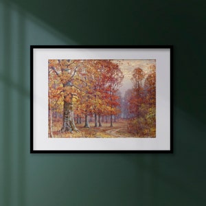 May include: A framed landscape painting depicting an autumn forest scene. The artwork features trees with vibrant orange and red foliage lining a winding path. The painting is set in a black frame and hangs on a dark green wall.