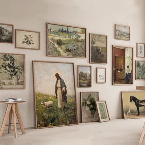 May include: A collection of framed art prints in various sizes and styles, including landscapes, floral arrangements, and religious figures. The frames are a light brown color, and the artwork features a vintage aesthetic.