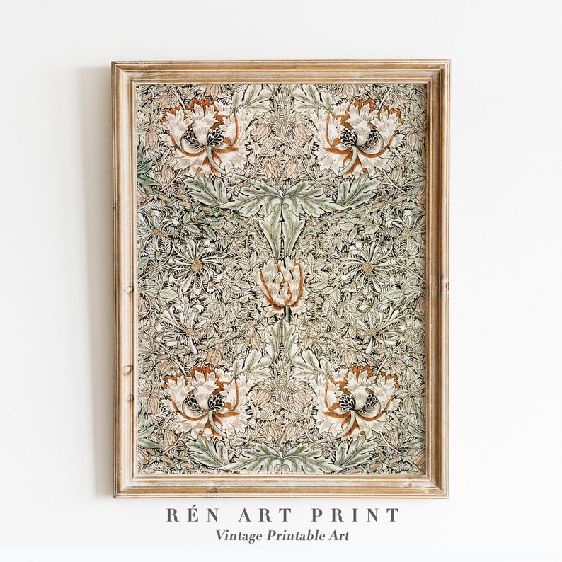 May include: A framed vintage print of a floral pattern in shades of green, brown, and white. The print features a repeating design of stylized flowers and leaves. The frame is a light wood color.