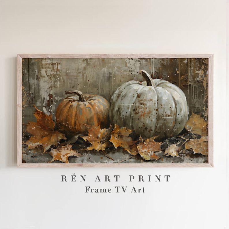 Puede incluir: Una pintura enmarcada de dos calabazas, una naranja y otra verde, con hojas de oto&ntilde;o esparcidas a su alrededor. La pintura tiene un fondo r&uacute;stico y texturizado y se titula "R&Eacute;N ART PRINT Frame TV Art".