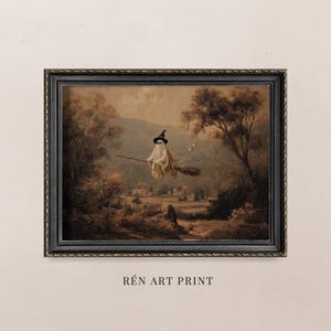 May include: A framed art print depicting a sepia-toned landscape with a ghost figure in a witch's hat, riding a broom. The artwork has a vintage aesthetic, with the text "RÉN ART PRINT" at the bottom.