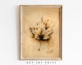 May include: A framed vintage art print featuring a detailed watercolor illustration of a maple leaf. The leaf is rendered in shades of brown and beige, with visible veins and a delicate stem. The artwork is set against a light brown background, with the text "RÉN ART PRINT Vintage Printable Art" at the bottom.
